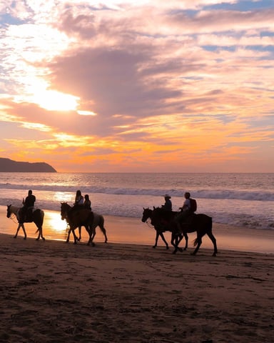 Horseback riding on the beach at sunset in Sayulita