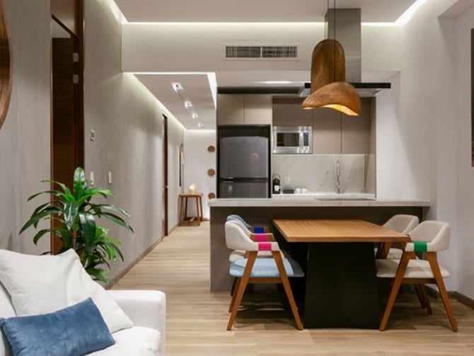 El Cielo apartment interior with kitchen island, dining area and warm lighting