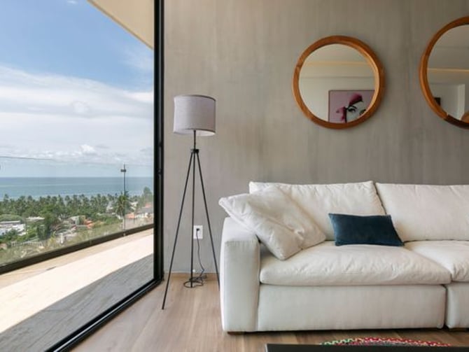 El Cielo apartment living room with white sofa and ocean view